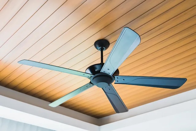 Black ceiling fan installed on wood plank ceiling — Quality Handyman Services Tampa
